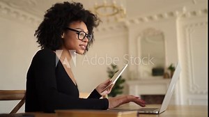 A female manager with computer glasses uses a laptop works in an office coworking space, prints a message