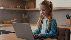 Modern tech addiction young generation social media addict concentrated little girl child teen daughter teenager at home kitchen alone engaged in playing video game on laptop computer typing pc device