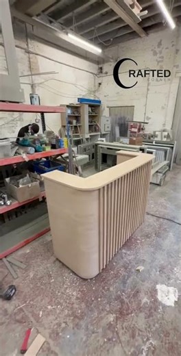 U-shaped white desk with a vertical tambour (fluted) panel