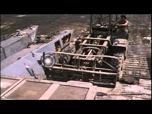 A fork lift unloads crates from US Navy landing craft LCM-8 at ramp and operator ...HD Stock Footage