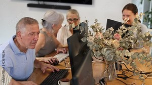 Focus on senior man who is learning to work on computer in a group of elderly people