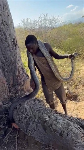 Why do these indigenous people wear snakes around their necks?