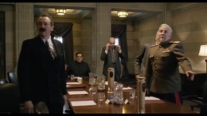 In this scene of The Death of Stalin (2017), Zhukov's popularity and power was shown where he gave his AK 47 to a guard that isn't part of his coup to punch Beria, and he just held it for him.