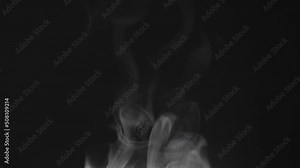 Steam Escaping from a Hot Drink. White steam rises light, graceful twists on a black background. The jet lifted out of the cup of hot water. Footage is perfect for the top layer with different blendin