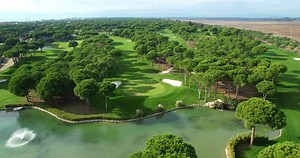 Aerial View of Pond with Fountain Located on Green Golf Course