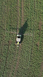 Aerial view of tractor spraying the field.