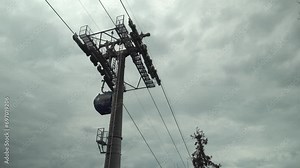 Funicular cable car cabin moves to destination, reaching the required point with ease. Recreational touristic experience against the overcast background. Tourist transportation on vacation