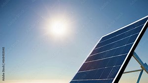 solar panel tilted towards sun against clear sky, sunlight reflection
