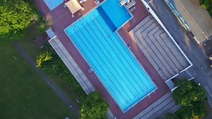 Breathtaking aerial top view rotation flight Berlin city Public swimming pool Germany in Europe, summer day 2023 | Premium Stock Video Footage