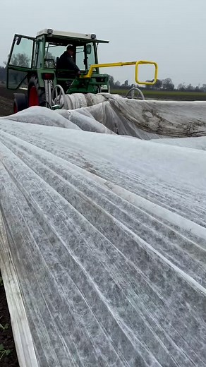 Tractor Operation: Covering Fields with Plastic Sheets