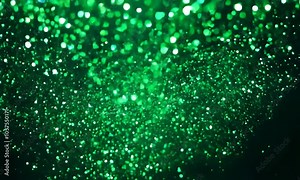 Emerald Glitter: A mesmerizing abstract background of emerald green glitter shimmering against a dark backdrop. Perfect for adding a touch of sparkle and celebration to your designs.