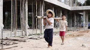 Children working at construction site. Poor children are forced to work in construction, Violence children and trafficking concept, Rights Day, World Day Against Child Labour concept