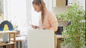 Artist unpacking new canvases. Female painter preparing for new artwork. Draw concept. Close-up in 4K, UHD