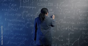 African American science teacher walking to chalk board and writing maths formula calculating thinking in classroom. Education and knowledge concept.