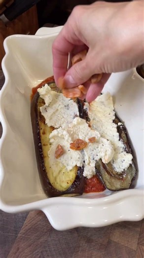 Grilled eggplant lasagna layered with mushroom tomato sauce, seasoned ricotta, sausage, and onions.