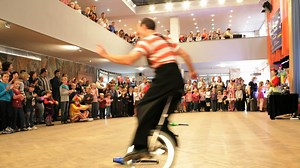 Download Clown riding a unicycle