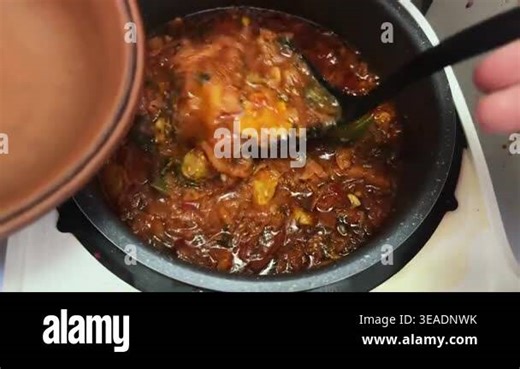 Pouring red borscht to clay bowl from multi-cooker pot Stock Video Footage - Alamy