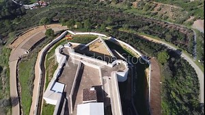 Aerial drone view of San Marcos Castle in a mountain of Sanlucar de Guadiana village in Huelva province, Andalusia, on the banks of Guadiana river, in the border of spain with portugal