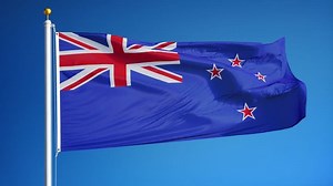 New Zealand flag waving in slow motion against blue sky, seamlessly looped, close up, isolated on alpha channel with black and white luminance matte, perfect for film, news, digital composition