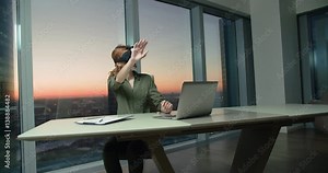 young girl Secretary works in the office using 3D glasses with the VR technology creates a virtual presentation