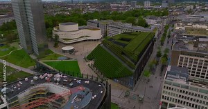 Establishing aerial shot revealing the largest green facade in Europe, a green building envelope to improve the city climate. Business center in Dusseldorf, Germany
