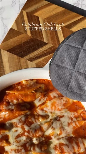 Calabrian Chili Crab Stuffed Shells Makes: 18-20 stuffed shells Ingredients Lump crab meat, 10 oz Old bay seasoning, 1 tsp Chopped parsley, 3 tbsp TJ's Calabrian chili pasta sauce, 18 oz Barilla jumbo pasta shells, 18-20 Tilamook mozzarella cheese, 2 cups Galbani ricotta cheese, 15 oz Mezzetta sundried tomatoes, 1 tbsp Grated parmesan, for topping 1 large egg Instructions Boil jumbo pasta shells almost al dente. In a bowl combine the ricotta, lump crab, old bay seasoning, 1 cup mozzarella, 2 tbs