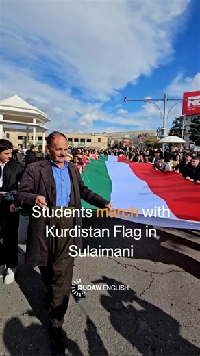 Students march with a large Kurdistan flag at Bardarki Sara Square in Sulaimani. | Rudaw English