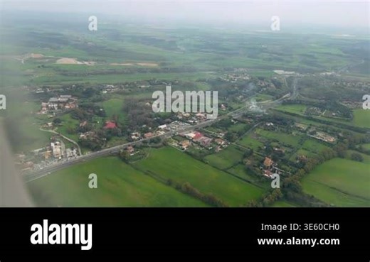 Aerial Countryside View With Winding Roads, Patchwork Fields, Clustered Village Homes, Roundabout And Highway Stock Video Footage - Alamy