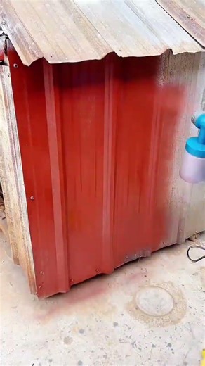Painting a Rusty Corrugated Metal Shed with Vibrant Red Paint Using a Corded Spray Gun