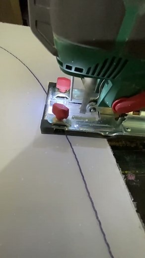 Cutting through clear plexiglass with jigsaw to shape a clear windshield for boat