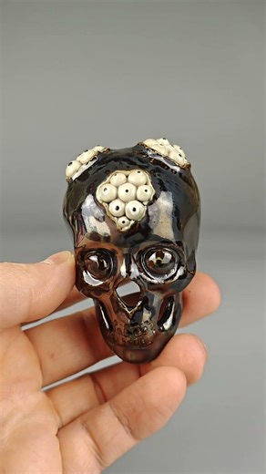 Dark metallic ceramic skull — altar art object & tea companion. Etsy: allinteaceramics.etsy.com