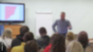 Male business coach teaching diverse business team at corporate training.