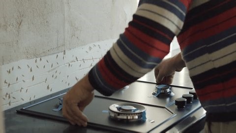 clip-3962653629-worker-installing-built-in-kitchen-stove-on-countertop