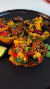 Asun-Snail Tostones cups topped with Mango Salsa Recipe ⬇️ ⬇️ Unripe plantains Vegetable oil Salt Goat meat Onions Garlic, minced Chicken bouillon cubes Dried thyme Curry powder White pepper Onion powder Scotch bonnet peppers Red bell pepper Medium snails, de-shelled Alum Lemon or lime Ripe mango Jalapeño pepper Fresh cilantro Limes • Peel and cut the green plantains into thick rounds, fry in hot oil until golden but not fully cooked. Flatten each one into a cup shape, then fry again until crisp