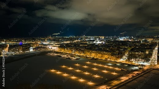 Hyperlapse drone shot sideways in front of the Helsinki skyline, winter evening