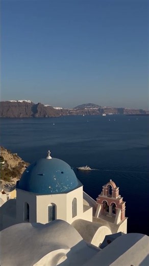 Oia Village Santorini: quiet early morning white pathways and soft pink sea horizon 4K