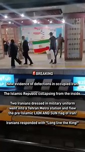 🚨BREAKING New evidence of defections in occupied Iran. The Islamic Republic collapsing from the inside. Two Iranians dressed in military uniform went into a Tehran Metro station and flew the pre-Islamic LION AND SUN flag of Iran! Iranians responded with “Long live the King!” | Goldie Ghamari