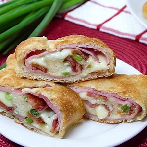 Delicious melted cheese, ham, bacon and green onion stromboli! Perfect for a weeknight or weekend dinner when you are pinched for time and are craving some Italian comfort food! Printable Recipe: https://mooreorlesscooking.com/2016/09/08/loaded-cheesy-ham-stromboli/ | Moore or Less Cooking Blog