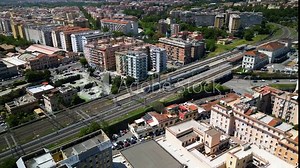 High-angle aerial perspective of Trastevere train station in Rome, showing the intricate street layout and urban landscape connected by pubic transit