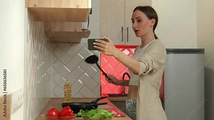 Female food blogger cooks food and records videos on a smartphone.
