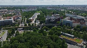 Aerial drone view of German Museum of Technology ( Deutsches Technikmuseum ) . Transport and technological museum with an airplane on the roof, set in a green park with windmills. Berlin , Germany