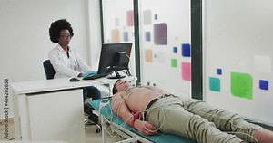 Doctor Fastens Electrodes To Patient. Install ECG Suckers. Hospital Nurse Fixing Electrodes On Patient Limbs For Cardiology Test, Equipment. Doctor Preparing Male Patient For Removal Of Cardiogram.