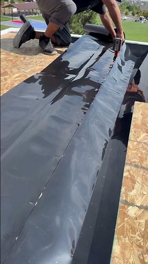 One staple at a time, we’re building a waterproof deck system that will keep the patio below dry.