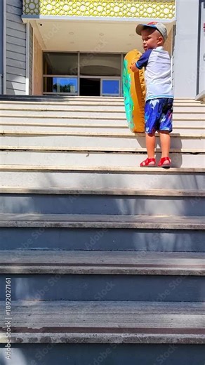 A boy in a cap and bathing shorts climbs the wide steps, holding a bright inflatable circle - a summer vacation by the pool.