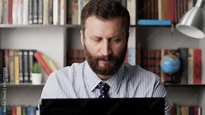 Upset disgruntled man at workplace typing on laptop keyboard and grumbling, cursing. Manager syndrome, burnout, stress, business problems, negative reaction, frustrated employee concept. Close-up