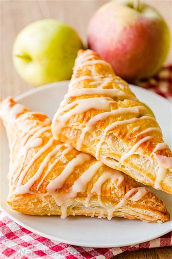 Homemade Apple Turnovers are puff pastry desserts stuffed with cinnamony apple filling that tastes like apple pie. Recipe: https://natashaskitchen.com/apple-turnovers/ | NatashasKitchen.com