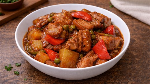Tender pork mechado cooked in savory tomato gravy