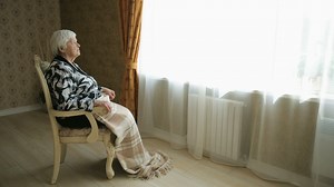 Elderly woman sitting in front of the window - Free Stock Video