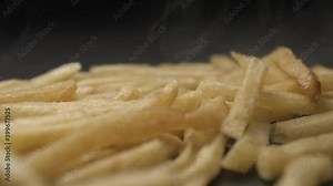 French fries with salt close up slow motion studio, tasty fast food
