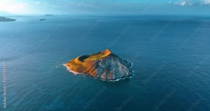Beautiful bare island surrounded by the Pacific Ocean. Aerial perspective on the Rabbit Island near Oahu, Hawaii, USA.
